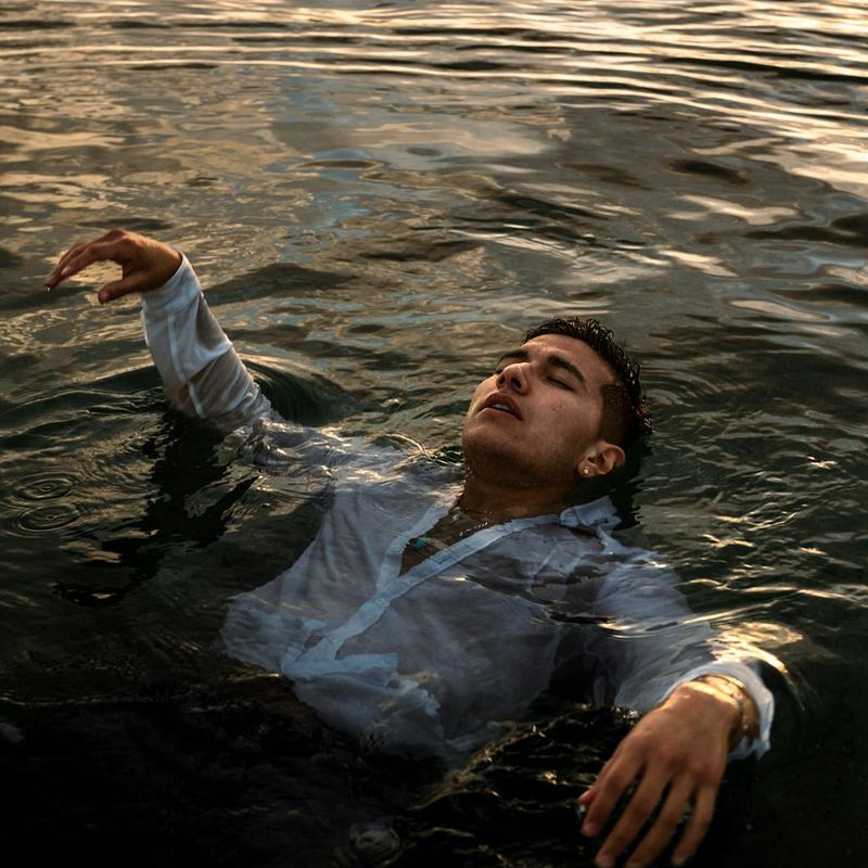 Person meditating peacefully with a backdrop of soft, warm light.