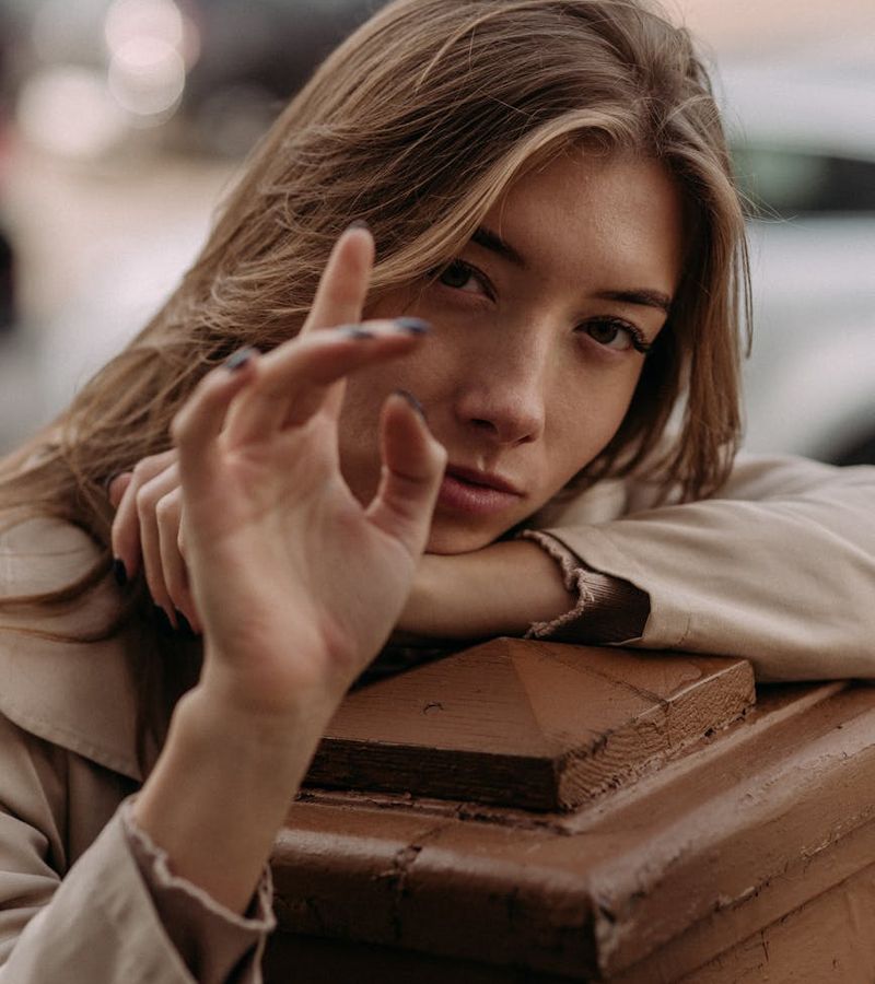 Woman in a calm yoga pose in a dark room with golden light.